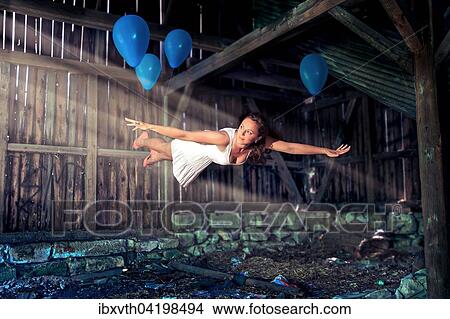 Young woman, blue balloons, levitation View Large Photo Image Picture - Young woman, blue balloons, levitation. Fotosearch