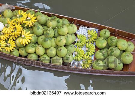 Stock Photo - A boat laden with fruit at the Damnoen Saduak floating market near Bangkok, Thailand, Asia. Fotosearch