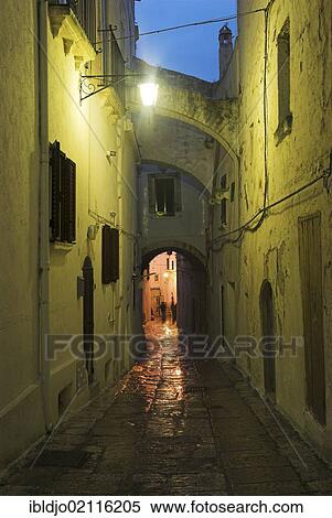 A narrow alleyway at night, Ostuni, Puglia, Apulia, Italy, Europe View Large Photo Image Stock Photography - A narrow alleyway at night, Ostuni, Puglia, Apulia, Italy, Europe. Fotosearch