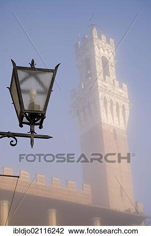 A street lamp in front of Torre del Mangia, obscured by thick morning fog, Palazzo Pubblico, Siena, Toscana, Italy, Europe View Large Photo Image Stock Image - A street lamp in front of Torre del Mangia, obscured by thick morning fog, Palazzo Pubblico, Siena, Toscana, Italy, Europe. Fotosearch