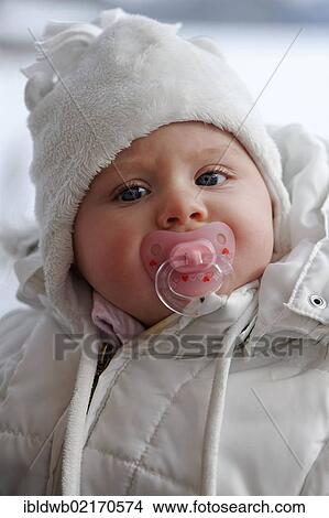 Baby, 6 month, wrapped in very warm winter clothing View Large Photo Image Picture - Baby, 6 month, wrapped in very warm winter clothing. Fotosearch