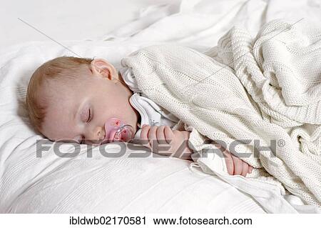 Baby, 6 months, sleeping with a dummy View Large Photo Image Stock Image - Baby, 6 months, sleeping with a dummy. Fotosearch