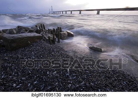 Stock Image - Baltic Sea beach and surf at Store Belt, Great Belt Bridge, Nyborg, Korsor, South Denmark, Denmark, Europe. Fotosearch