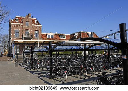 Bicycles parked at the railway station in Enkhuizen, North Holland, Holland, Netherlands, Europe View Large Photo Image Stock Photo - Bicycles parked at the railway station in Enkhuizen, North Holland, Holland, Netherlands, Europe. Fotosearch