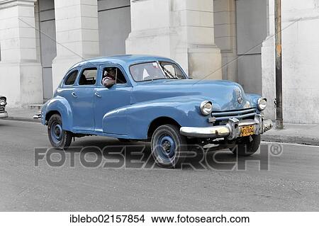 Picture - Blue 1950's vintage car in the Avenida Simon Bolivar, Calle Reina, town centre of Havana, Central Habana, Cuba, Greater Antilles, Caribbean, Central America, America, North America. Fotosearch