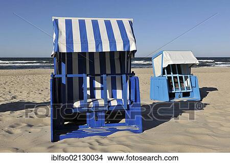 Blue and white roofed wicker beach chairs on a beach near Goehren, Ruegen, Mecklenburg-Western Pomerania, Germany, Europe View Large Photo Image Picture - Blue and white roofed wicker beach chairs on a beach near Goehren, Ruegen, Mecklenburg-Western Pomerania, Germany, Europe. Fotosearch