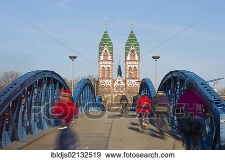 Stock Photo - Blue Bridge and cyclists with motion blur, Freiburg im Breisgau, Black Forest, Baden-Wuerttemberg, Germany, Europe. Fotosearch