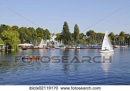 Stock Image - Boat hire and Bobby Reich Restaurant on lake Aussenalster, Outer Alster Lake, Harvestehude, Winterhude, Hamburg, Germany, Europe. Fotosearch