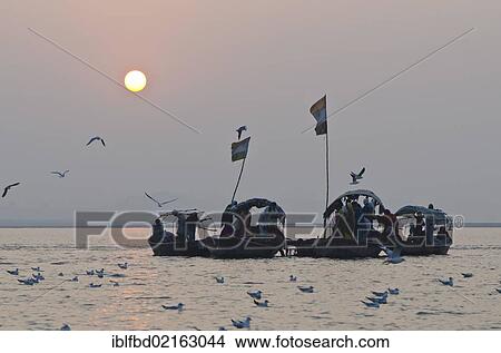 Boats with pilgrims at Sangam, the confluence of the holy rivers Ganges, Yamuna and Saraswati, in Allahabad, Uttar Pradesh, India, Asia View Large Photo Image Picture - Boats with pilgrims at Sangam, the confluence of the holy rivers Ganges, Yamuna and Saraswati, in Allahabad, Uttar Pradesh, India, Asia. Fotosearch