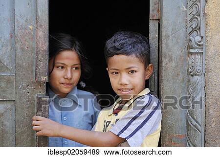 Boy and girl standing in the doorway, Bhaktapur, Kathmandu Valley, Nepal, Asia View Large Photo Image Stock Photo - Boy and girl standing in the doorway, Bhaktapur, Kathmandu Valley, Nepal, Asia. Fotosearch