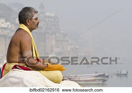 Brahmin man meditating at the holy river Ganges in the morning, Varanasi, Uttar Pradesh, India, Asia View Large Photo Image Stock Photograph - Brahmin man meditating at the holy river Ganges in the morning, Varanasi, Uttar Pradesh, India, Asia. Fotosearch