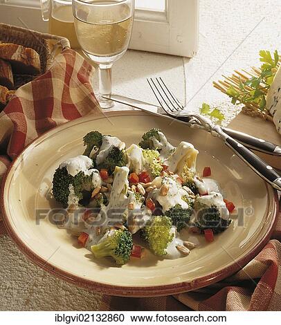 Stock Image - Broccoli salad with Roquefort sauce, with diced peppers and sunflower seeds, France, Europe. Fotosearch