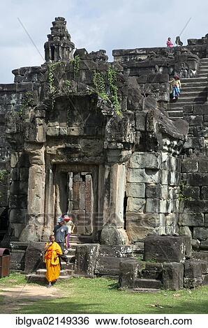 Buddhist monk and visitors at the entrance tower of Bakong Temple, Roluos Group, Angkor, Siem Reap, Cambodia, Southeast Asia, Asia View Large Photo Image Stock Photograph - Buddhist monk and visitors at the entrance tower of Bakong Temple, Roluos Group, Angkor, Siem Reap, Cambodia, Southeast Asia, Asia. Fotosearch