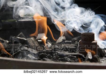 Stock Photo - Burning charcoal in a barbecue. Fotosearch