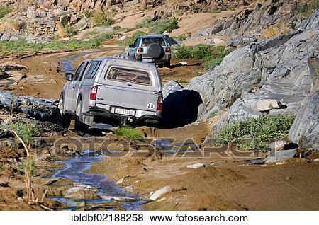 Car on a road, crossing a river, Richtersveld National Park, Northern Cape, South Africa, Africa View Large Photo Image Stock Photo - Car on a road, crossing a river, Richtersveld National Park, Northern Cape, South Africa, Africa. Fotosearch