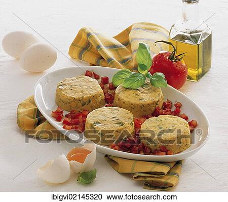 Stock Image - Carrot flan with asparagus and tomato dressing, hot starter, Italy, Europe. Fotosearch