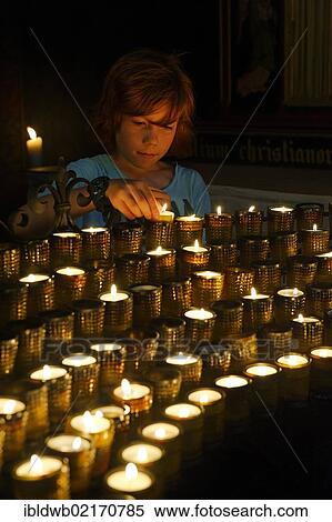 Child lighting a votive candle in a church, Cathedral of St Peter, Worms Cathedral, Worms, Rhineland-Palatinate, Germany, Europe View Large Photo Image Stock Photography - Child lighting a votive candle in a church, Cathedral of St Peter, Worms Cathedral, Worms, Rhineland-Palatinate, Germany, Europe. Fotosearch