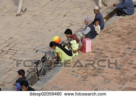 Stock Image - Child, women and men on the Taumadhi square, Bhaktapur, Kathmandu Valley, Nepal, Asia. Fotosearch