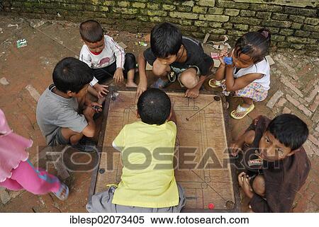 Stock Photography - Children playing board game, Bhaktapur, Kathmandu Valley, Nepal, Asia. Fotosearch
