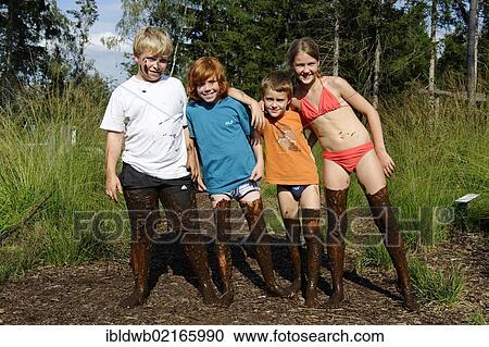 Children smeared with mud, mud bath in the Sterntaler Filze, moorland, peat fields in Bad Feilnbach, Upper Bavaria, Bavaria, Germany, Europe View Large Photo Image Stock Image - Children smeared with mud, mud bath in the Sterntaler Filze, moorland, peat fields in Bad Feilnbach, Upper Bavaria, Bavaria, Germany, Europe. Fotosearch