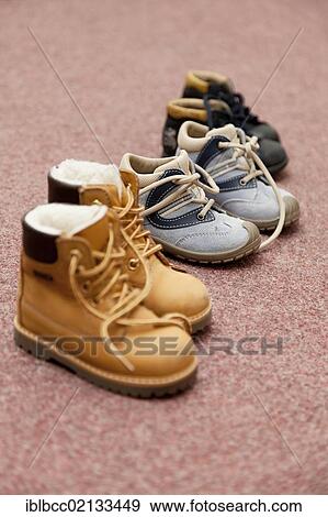 Stock Photo - Children's shoes and boots in a row. Fotosearch