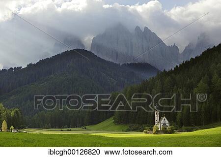 Stock Image - Church in St. Johann in Ranui and the Geisler mountain range, Villnößtal, South Tyrol, Italy, Europe. Fotosearch