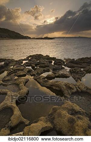 Colorful sunrise clouds above the typical salt pans or salterns, near Ghajnsielem, southern coast of Gozo, Malta, Europe View Large Photo Image Stock Image - Colorful sunrise clouds above the typical salt pans or salterns, near Ghajnsielem, southern coast of Gozo, Malta, Europe. Fotosearch