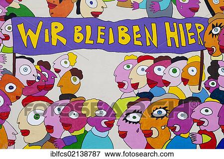 Colourful graffiti "Wir bleiben hier", German for "We stay here", on the external side wall of the Marriott hotel in Leipzig, Saxony, Germany, Europe View Large Photo Image Stock Photo - Colourful graffiti "Wir bleiben hier", German for "We stay here", on the external side wall of the Marriott hotel in Leipzig, Saxony, Germany, Europe. Fotosearch