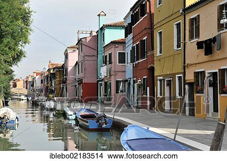 Colourful painted houses, boats in the canal of Burano, Burano Island in the lagoon of Venice, Italy, Europe View Large Photo Image Picture - Colourful painted houses, boats in the canal of Burano, Burano Island in the lagoon of Venice, Italy, Europe. Fotosearch