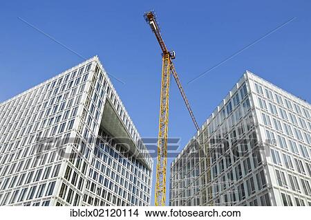 Construction site at Ericusspitze, construction crane between two new office buildings, HafenCity, Hamburg, Germany, Europe View Large Photo Image Picture - Construction site at Ericusspitze, construction crane between two new office buildings, HafenCity, Hamburg, Germany, Europe. Fotosearch