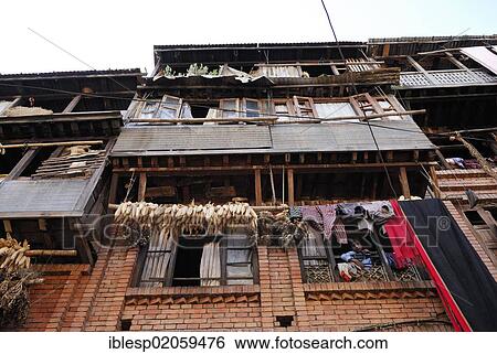Stock Photograph - Corn and laundry hanging on a washing line to dry, houses, Bhaktapur, Kathmandu Valley, Nepal, Asia. Fotosearch