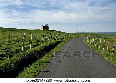 Stock Image - Country road in Cezallier, Auvergne, France, Europe. Fotosearch
