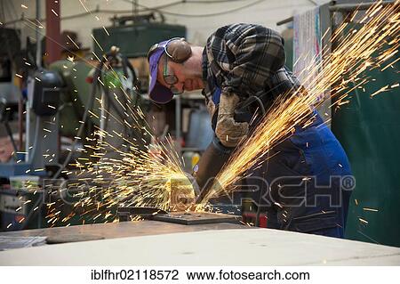 Craftsmen working with an angle grinder in his workshop View Large Photo Image Stock Image - Craftsmen working with an angle grinder in his workshop. Fotosearch