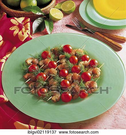 Stock Photo - Creole shrimp skewers with cherry tomatoes and dill, cold starter, Caribbean. Fotosearch