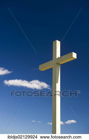 Cross against a blue sky with cumulus clouds View Large Photo Image Picture - Cross against a blue sky with cumulus clouds. Fotosearch