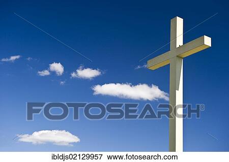 Cross against a blue sky with cumulus clouds View Large Photo Image Stock Photo - Cross against a blue sky with cumulus clouds. Fotosearch