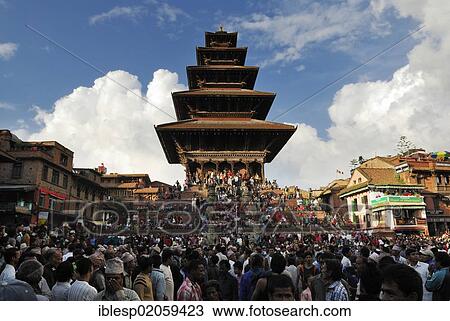 Stock Image - Crowd, procession, Nyatapola Pagoda, Taumadhi square, Bhaktapur, Kathmandu Valley, Nepal, Asia. Fotosearch