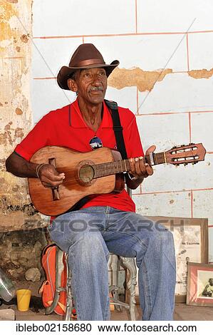 Stock Image - Cuban musician in a side street, old town, Trinidad, Cuba, Greater Antilles, Caribbean, Central America, America, North America. Fotosearch