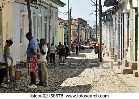 Stock Photo - Cubans standing in a side street, cobbled street, old town, Trinidad, Cuba, Greater Antilles, Caribbean, Central America, America, North America. Fotosearch