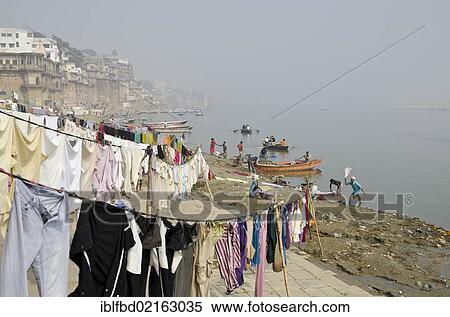 Stock Photography - Dhobi walas, people of the laundry cast, doing laundry at the ghats along the holy river Ganges, Varanasi, Uttar Pradesh, India, Asia. Fotosearch
