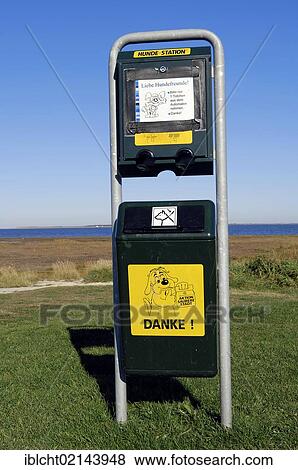 Dispenser with bags for dog faeces and a garbage can, Dornumersiel, East Frisia, Lower Saxony, Germany, Europe View Large Photo Image Stock Photo - Dispenser with bags for dog faeces and a garbage can, Dornumersiel, East Frisia, Lower Saxony, Germany, Europe. Fotosearch