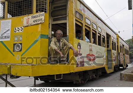 Driver of an old Kolkata tram resting at a red traffic-light, Kolkata, West Bengal, India, Asia View Large Photo Image Picture - Driver of an old Kolkata tram resting at a red traffic-light, Kolkata, West Bengal, India, Asia. Fotosearch