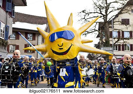 Drum major of a Guggenmusik group, carnival marching band, dressed as the sun, 35th Motteri parade in Malters, Lucerne, Switzerland, Europe View Large Photo Image Stock Image - Drum major of a Guggenmusik group, carnival marching band, dressed as the sun, 35th Motteri parade in Malters, Lucerne, Switzerland, Europe. Fotosearch