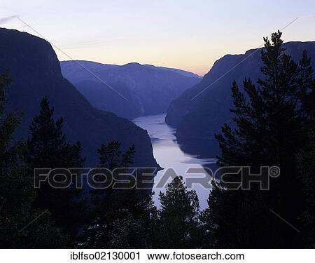 Stock Image - Dusk on Aurlandsfjord, seen from the old pass road above the town of Aurland, Sogn og Fjordane, Norway, Europe. Fotosearch