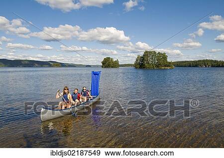 Family canoeing on a lake near Bengtsfors, Dalsland, Sweden, Europe View Large Photo Image Stock Photo - Family canoeing on a lake near Bengtsfors, Dalsland, Sweden, Europe. Fotosearch