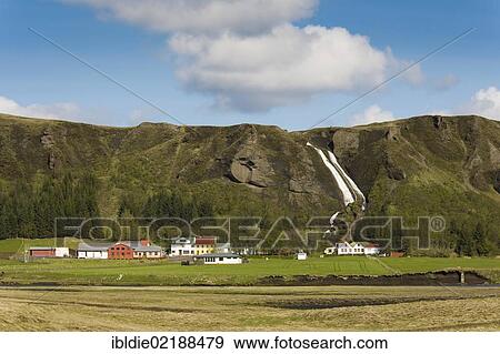 Farms in front of a waterfall, Kirkjubaerjaklaustur, South Iceland, Iceland, Northern Europe, Europe View Large Photo Image Stock Photo - Farms in front of a waterfall, Kirkjubaerjaklaustur, South Iceland, Iceland, Northern Europe, Europe. Fotosearch