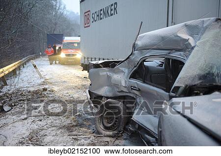 Stock Image - Fatal car accident on the slippery snow of an icy road, an E-Class Mercedes was hurled onto the opposite carriageway and collided with an oncoming truck, Stuttgart, Baden-Wuerttemberg, Germany, Europe. Fotosearch