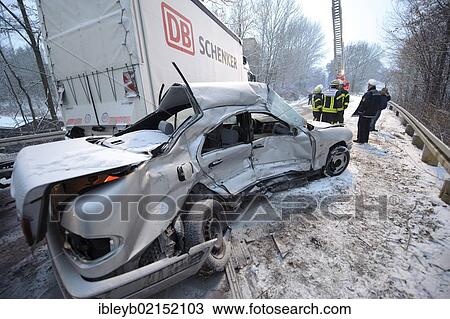 Stock Image - Fatal car accident on the slippery snow of an icy road, an E-Class Mercedes was hurled onto the opposite carriageway and collided with an oncoming truck, Stuttgart, Baden-Wuerttemberg, Germany, Europe. Fotosearch