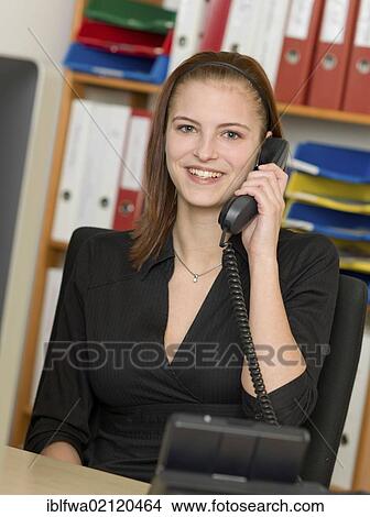 Female office worker making a telephone call View Large Photo Image Picture - Female office worker making a telephone call. Fotosearch