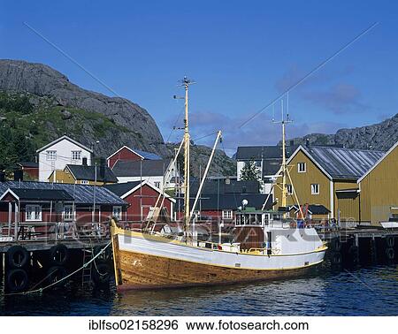 Stock Photograph - Fishing boat in the harbour of Nusfjord, Flakstadøya Island, Lofoten Islands, Norway, Scandinavia, Europe. Fotosearch